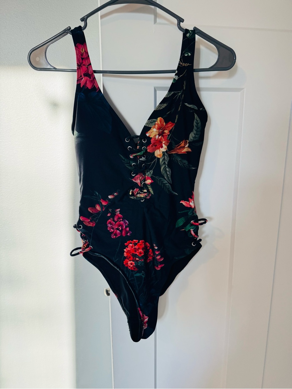 TiNiBiKiNi Black One-Piece Swimsuit with Orange Floral Accent